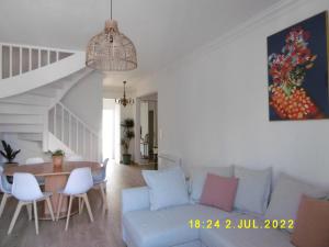 a living room with a couch and a table at Le Doubs Vesontio in Besançon