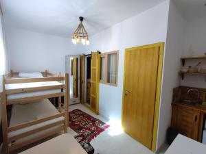 a room with several bunk beds and a door at Sebilhan Apart Hotel in Sarajevo