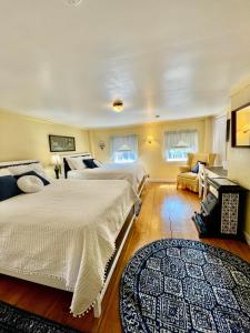 1 dormitorio con 2 camas y alfombra en Clark Currier Inn en Newburyport