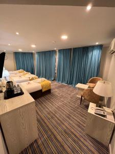 a hotel room with a row of beds at فندق الميقات أجياد in Mecca