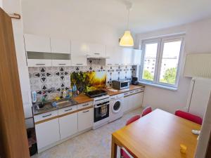 a kitchen with white cabinets and a stove top oven at Comfortable and quiet flat in Central Warsaw in Warsaw
