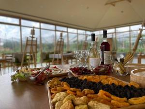 a table with plates of food and bottles of wine at Green Training Center in Dzoraghpʼyur
