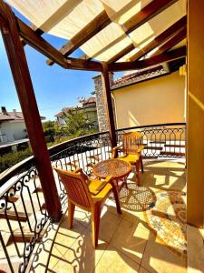a patio with two chairs and a table on a balcony at Villa Mor Fethiye in Fethiye
