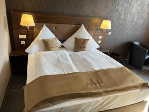 uma grande cama branca num quarto com 2 candeeiros em Hotel Pasa Paradies KOSTENLOSE PARKPLÄTZE em Hanau am Main