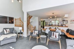 a living room filled with furniture and a dining room at 4 Storey Ski Inout Mountain Home In Tremblant in Mont-Tremblant
