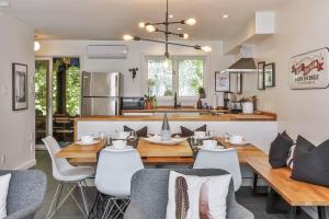 a kitchen and dining room with a table and chairs at 4 Storey Ski Inout Mountain Home In Tremblant in Mont-Tremblant