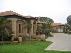 a house with a driveway in front of it at Witwater Guest House & Spa in Kempton Park