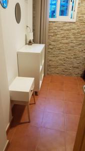 a room with a white dresser and a chair at Joy Beach B&B in Torremolinos