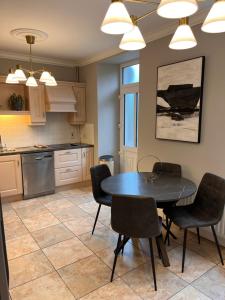 a kitchen with a dining room table and chairs at No10bridgestreet in Westport