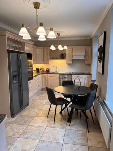 a kitchen with a table and chairs and a refrigerator at No10bridgestreet in Westport +20 photos