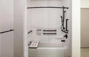 a white bathroom with a tub and a sink at Atwell Suites - DENVER AIRPORT TOWER ROAD by IHG in Denver +41 photos