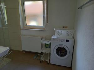 uma lavandaria com uma máquina de lavar roupa e uma janela em Ferienwohnung Riposo em Meersburg