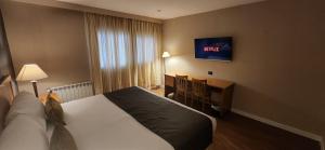 Cama ou camas em um quarto em Hotel Canal Beagle