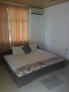 a large bed in a room with a window at Abuesi Beach Resort in Sekondi-Takoradi +53 photos