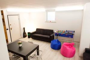 a living room with a couch and a table at Villa Green in Pianezza