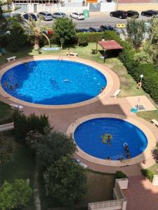 an overhead view of a large blue swimming pool at apartamento Gandiazar 4 playa, VT-52979-V in Playa de Gandia