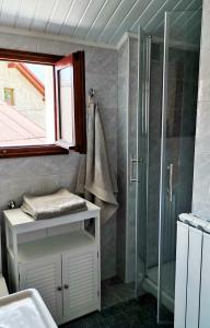 a bathroom with a glass shower and a sink at Pri Zajcu in Bovec