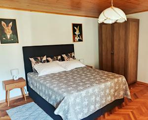 a bedroom with a bed and a wooden floor at Pri Zajcu in Bovec