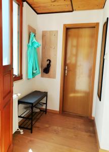 a hallway with a door and a bench in a room at Pri Zajcu in Bovec