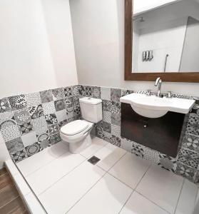 a bathroom with a toilet and a sink at Hotel Patagonia Signature in San Carlos de Bariloche