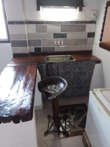 a small kitchen with a sink and a stool at Villa Azul in Buenos Aires +40 photos