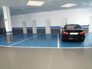 a car is parked in a parking garage at Apartamento Zona Playa y centro Ciudad in Santander