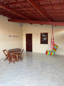 a dining room with a table and two chairs at Suíte Brisa Mar Villa brisa icaraizinho in Amontada
