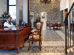 a man sitting at a desk with a laptop at Europa 1917 - Mehadrin Kosher suitable for Ultra-Orthodox guests in Tiberias +106 photos