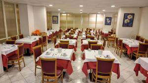 a dining room with white tables and chairs at Hotel Regina in Lignano Sabbiadoro +37 photos