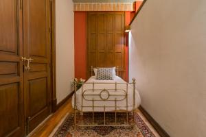 a bedroom with a white bed in a hallway at CASA SAUTO Family Suite next to the Cathedral in Mexico City