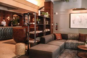 a living room with a couch and a bar at Dossier in Portland