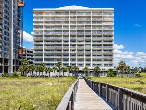 a building with a boardwalk in front of it at Tidewater Orange Beach #1003 in Orange Beach