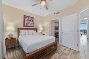 a bedroom with a bed and a ceiling fan at Beach Club C-509 in Gulf Shores