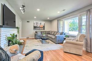 a living room with couches and a large window at Charming Springfield Home with Private Backyard in Springfield