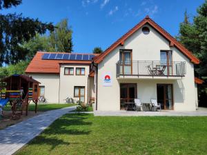 a house with solar panels on the roof at Zorza in Sztutowo