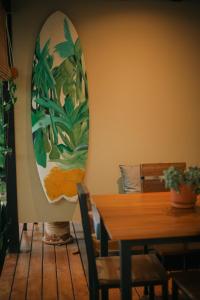 a dining room with a table and a large painting on the wall at El Hábita CASA SELVA in Santa Teresa Beach