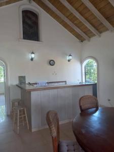 a kitchen with a wooden table and a counter at casa maria in La Romana