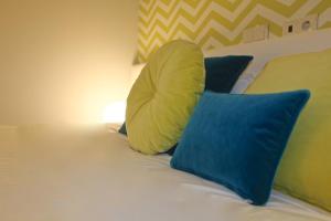 
a bed with pillows and pillows on top of it at Aqua Ria Boutique Hotel in Faro
