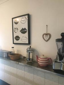 a kitchen counter with a picture of lips on the wall at Clifton Lodge in Lytham St Annes