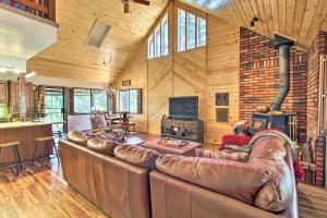 a large living room with a leather couch and a television at Deck, Porch and Grill Heber-Overgaard Getaway! in Heber