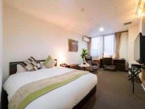 Postel nebo postele na pokoji v ubytování Hotel Tohkai