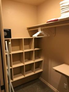 a closet with white shelves in a room at Mountain View Apartment, Residential Area, Private Entrance in Sedona