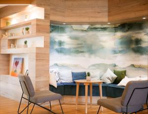 a room with a couch and two chairs and a table at Best Western Le Bois de la Marche in Poitiers