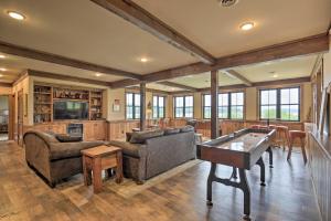 a living room with a ping pong table at Waterfront Star Lake Cabin, Boat Dock On-Site in Sayner