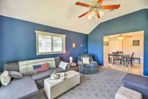 a living room with a couch and a ceiling fan at Kayaks and Grill Pet-Friendly Mecosta Cottage! in Mecosta +22 photos