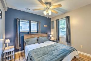 a bedroom with a bed and a ceiling fan at Kayaks and Grill Pet-Friendly Mecosta Cottage! in Mecosta