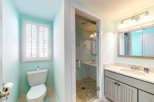 a bathroom with a toilet and a sink and a shower at Town of Bethany Beach - 114 Campbell Place in Bethany Beach +36 photos