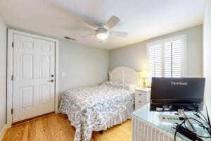 a bedroom with a bed and a laptop on a table at Town of Bethany Beach - 114 Campbell Place in Bethany Beach