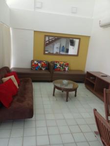uma sala de estar com um sofá e uma mesa em Flat no ancorar flat resort em Porto de Galinhas