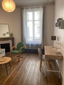 salon ze stołem i krzesłami oraz oknem w obiekcie Pasteur T3 de charme Artem parc Ste Marie w Nancy